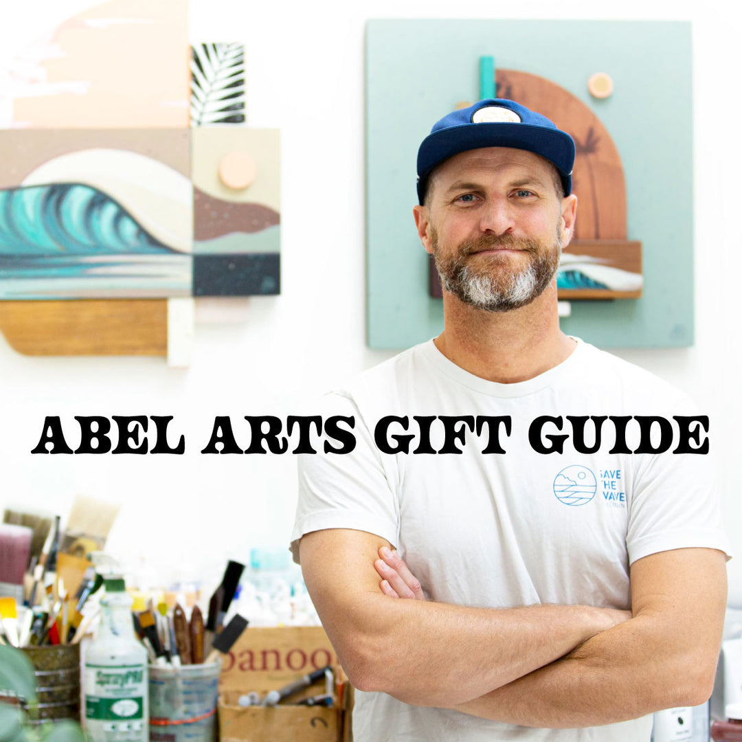 PNW Artist with painting tools and prints in the background- Erik Abel Art Gift Guide